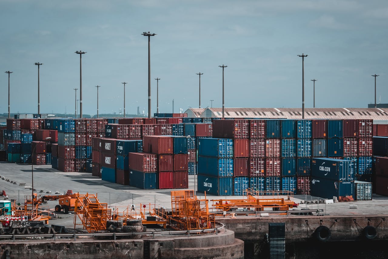 Colorful cargo containers stacked at a busy industrial port, showcasing global trade.